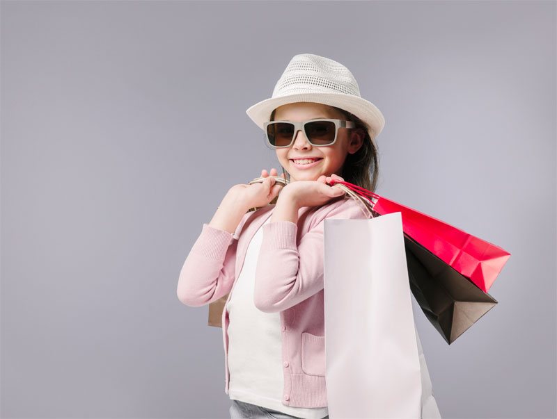 A smiling shopper holding shopping bags